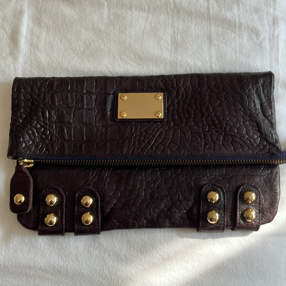 LINEA PELLE leather fold over clutch. Color: Viola (deep purple)